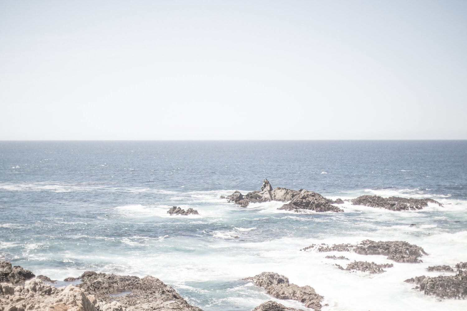The ocean from a rocky shore, with waves crashing against the rocks, is a beautiful place for meditation for beginners.