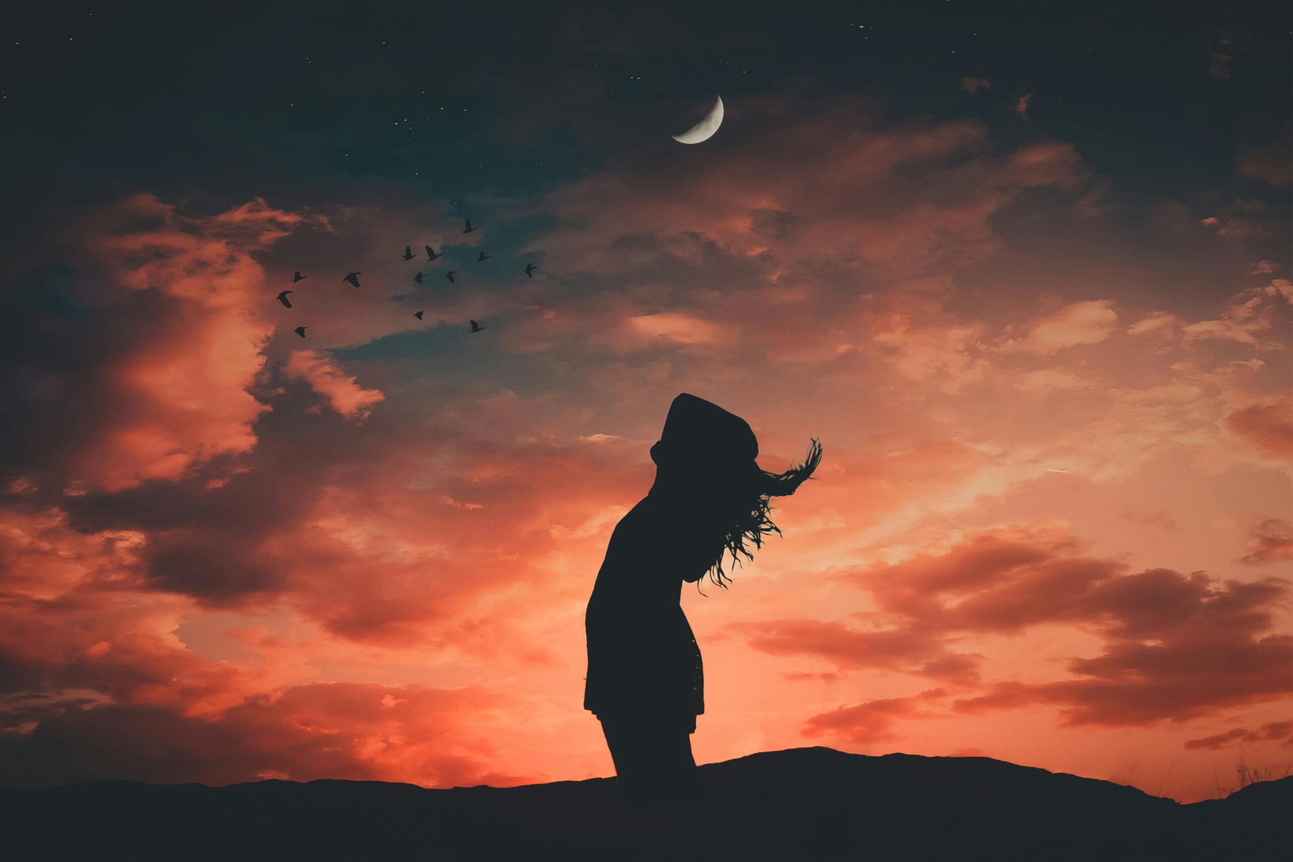 A silhouetted person under a crescent moon at twilight, evoking tranquil and peaceful vibes, portraying the mindfulness of long-term recovery.